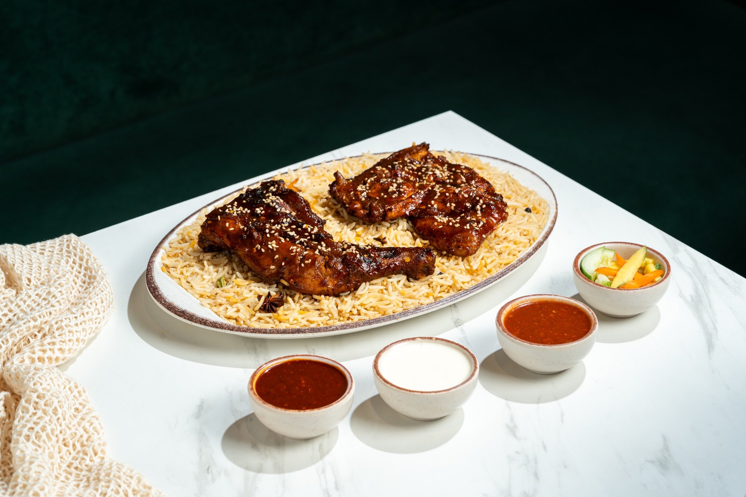 Honey Fire Mandi on mandi rice, with three sauces and pickles